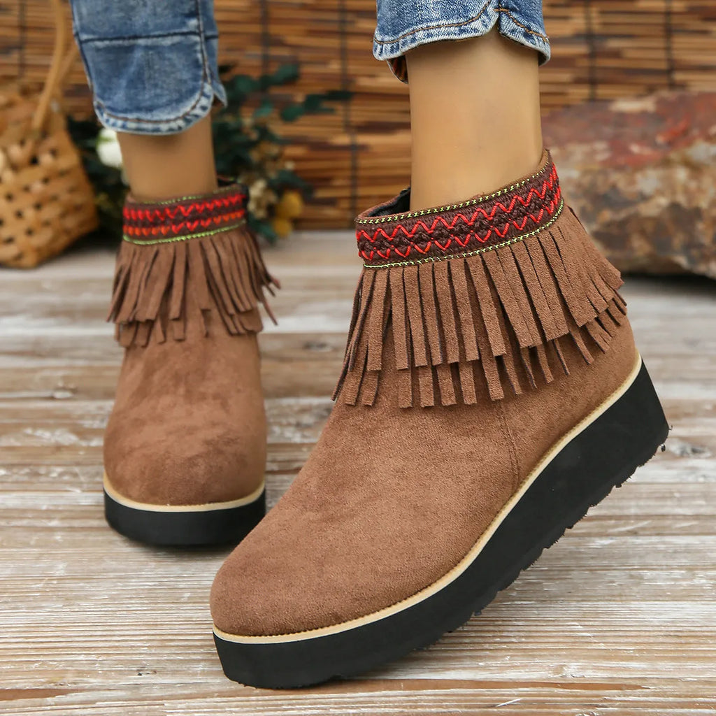 Women's dark brown suede wedge ankle boots with a side zipper and decorative tassels.