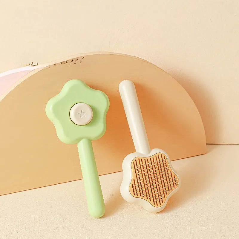 Green or yellow handheld self-cleaning magic wand pet comb with stainless steel needles.