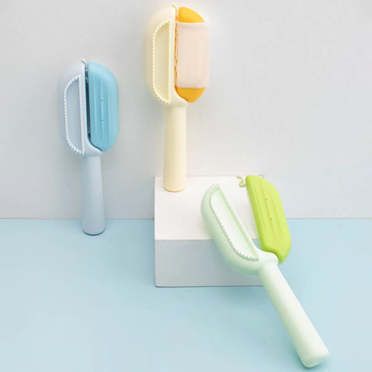 Blue plastic pet grooming comb with a water tank for cleaning dog and cat hair.