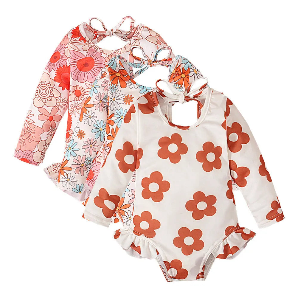 Girl's floral print swimsuit with crew neck and open back in orange red colour.