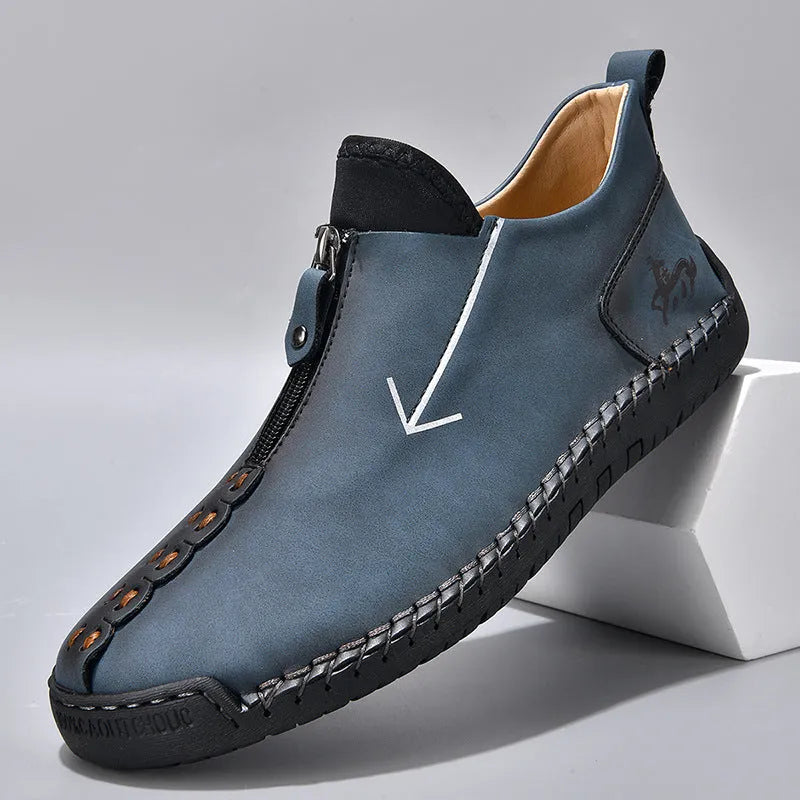 Men's brown zip-up Martin boots with round toe and hand-stitched rubber sole on a neutral background.