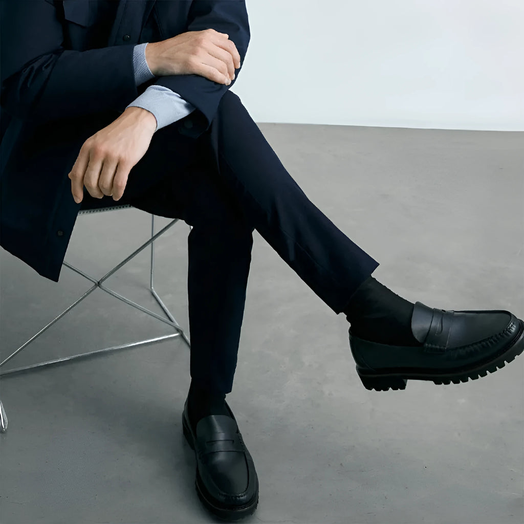 Men's brown leather loafers with first layer cowhide upper, rubber sole, and low heel on a neutral background