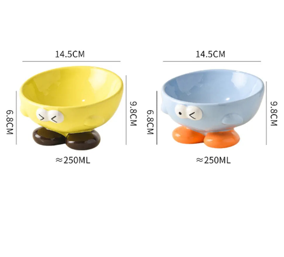 Blue ceramic oblique pet bowl with tall sides and a cute expression print for cervical spine support.