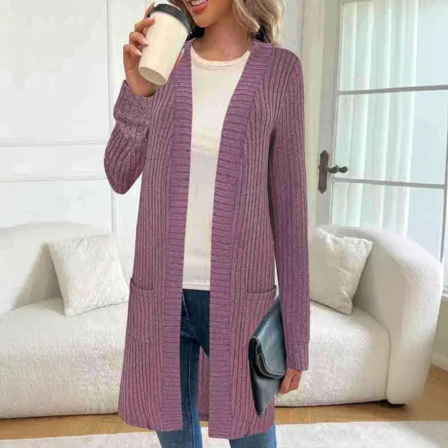 A woman wearing a loose-fit long sleeve knitted cardigan jacket with pockets, available in black, grey, or wine red.
