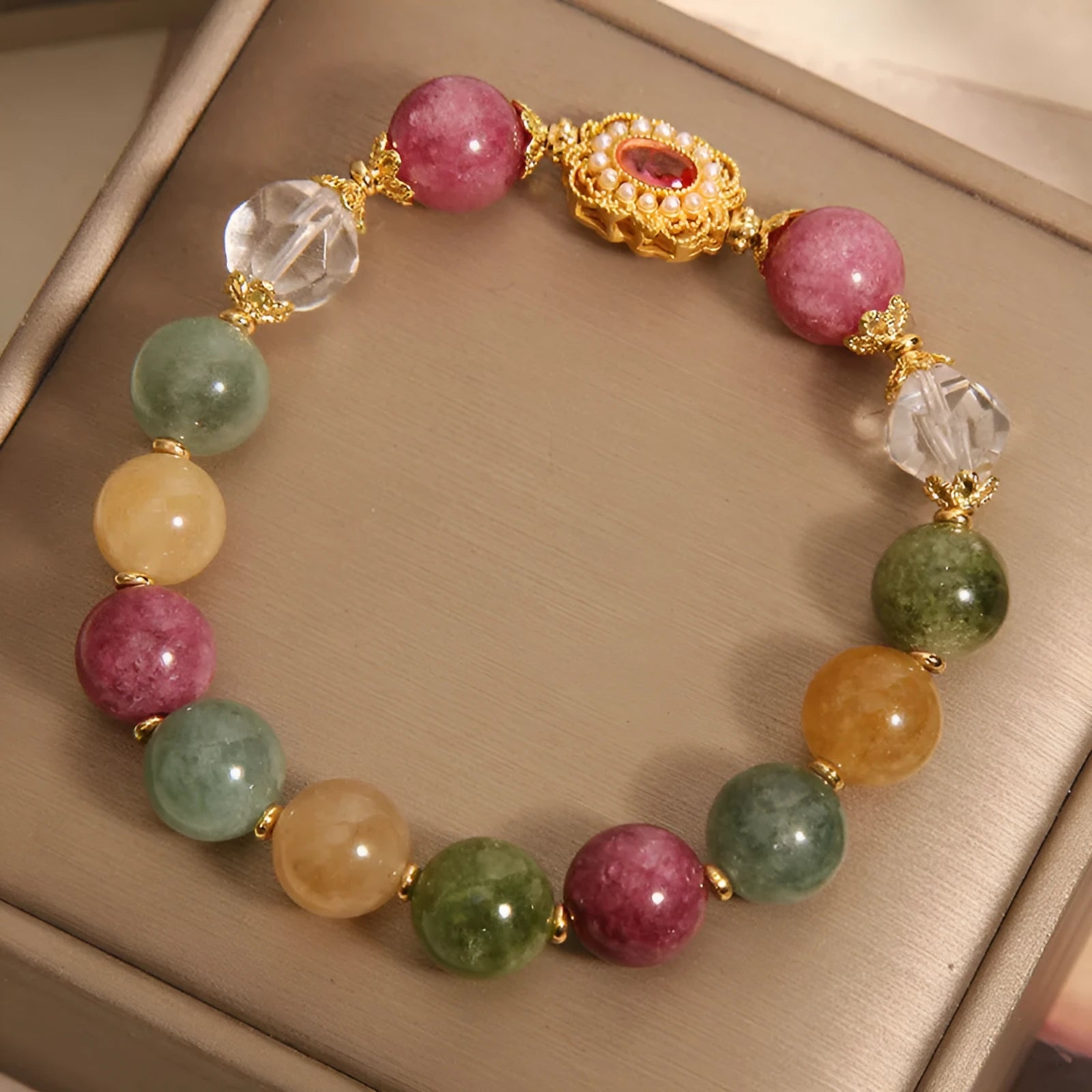 Close-up of a jade colour tourmaline bead bracelet on a pearl crystal base with alloy setting and rhinestones.