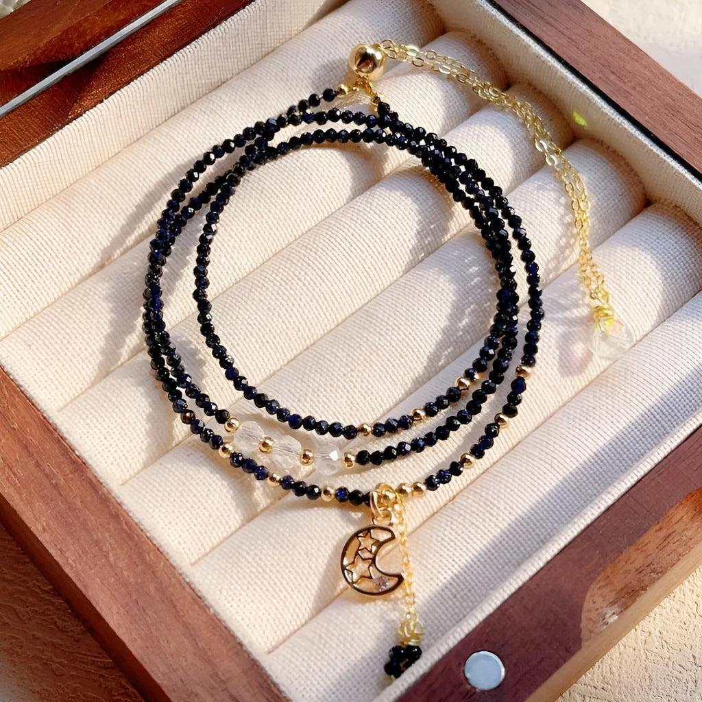 Women's blue sand stone and gold three-ring multi-layer bracelet on wrist