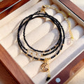 Women's blue sand stone and gold three-ring multi-layer bracelet on wrist