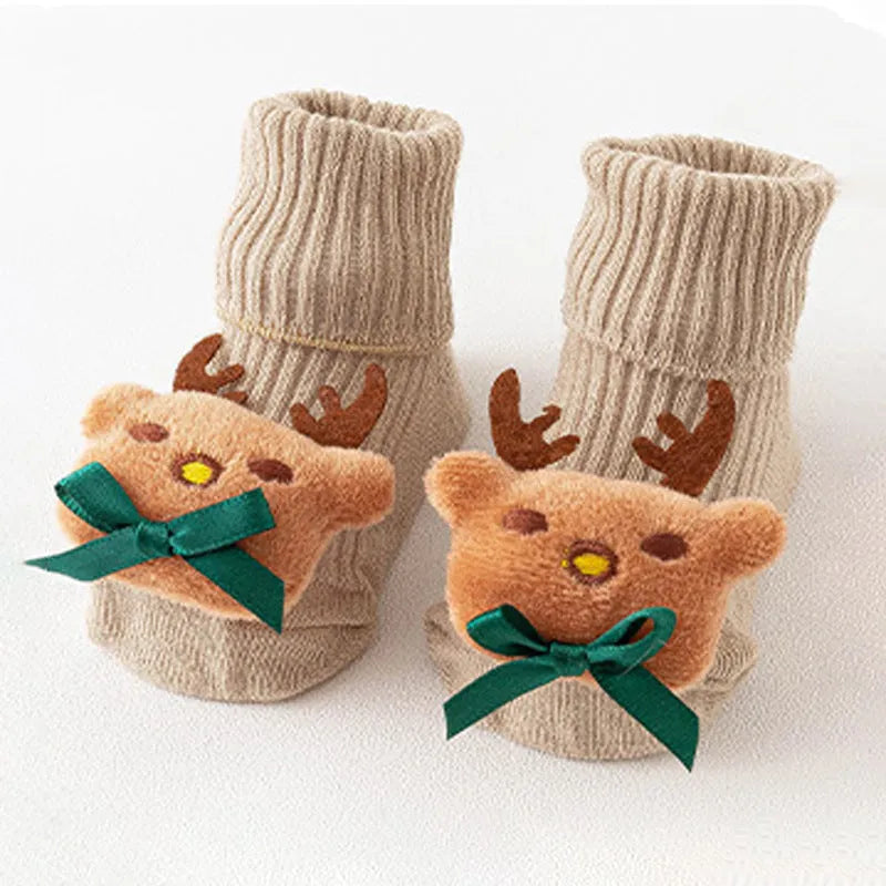 Cotton baby floor socks in a pink bow pattern, shown on an infant's feet.