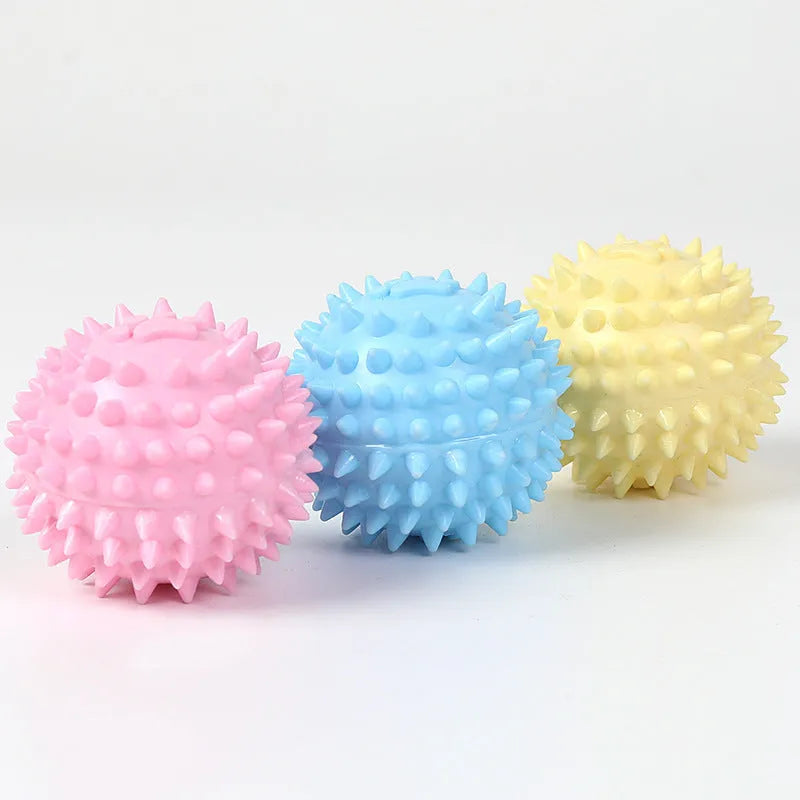 Blue TPR dog chew ball with textured footprint pattern and tooth cleaning nubs