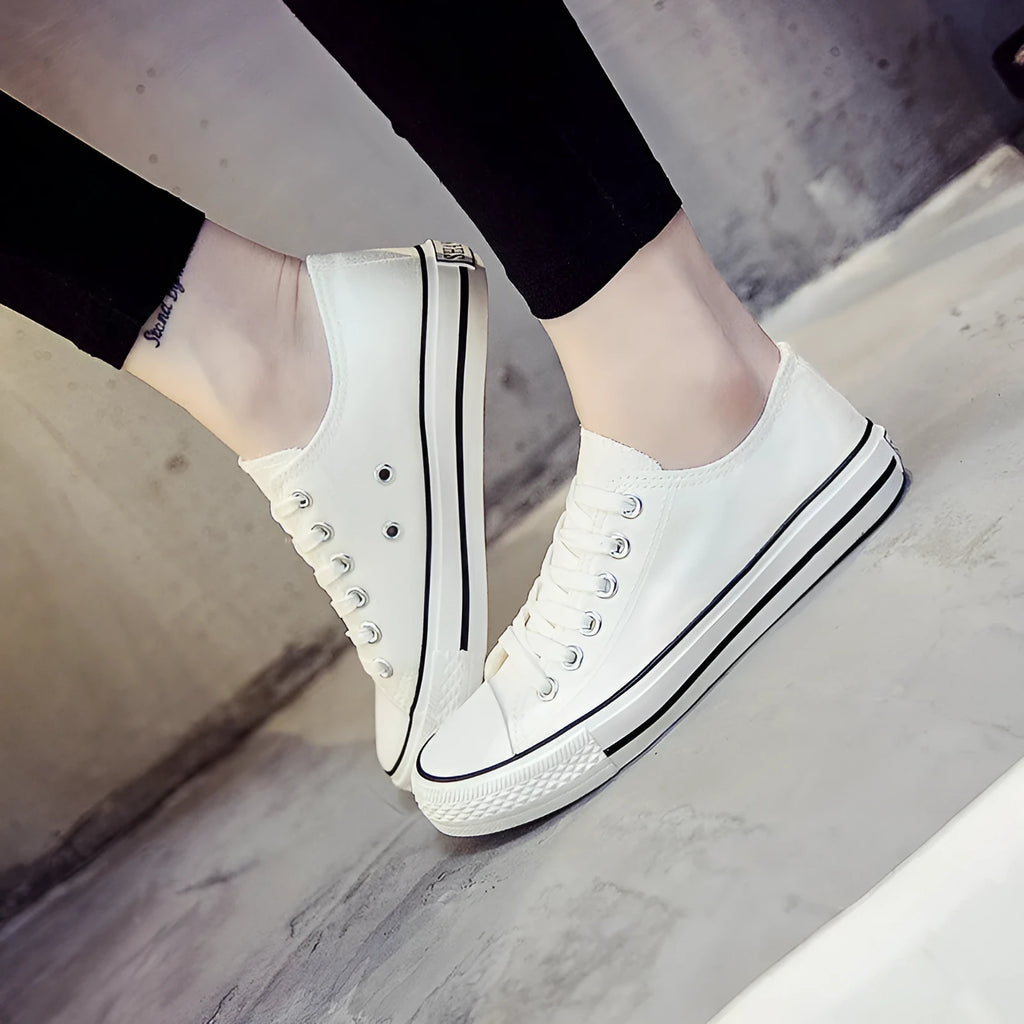 Women's casual canvas shoes in solid colours: all-black, black, white-black, and white-red.