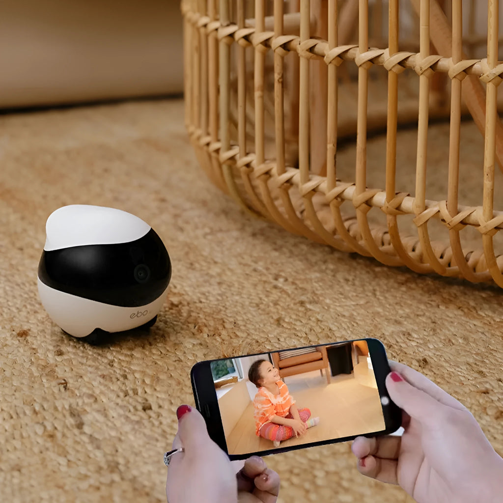 White mobile robot security camera with automatic docking station