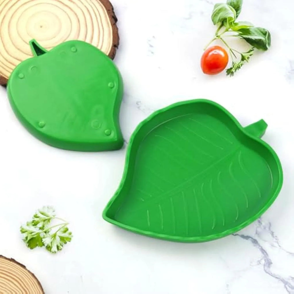 Two leaf-shaped reptile food and water bowls in green, large and small, on a white background.