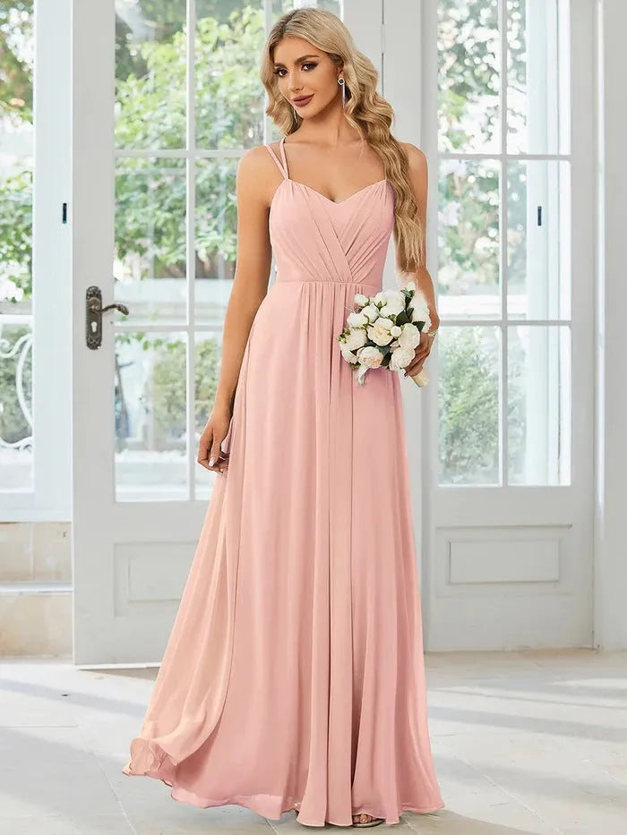 Sleeveless long pleated A-line women's dress in light green polyester fabric, shown on a model.