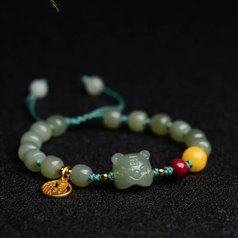 Natural Hetian jade bracelet with zodiac modelling, cinnabar and beeswax beads, and sequin detail.