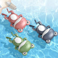 Little Frog clockwork floating bath toy in Coral Red on water surface