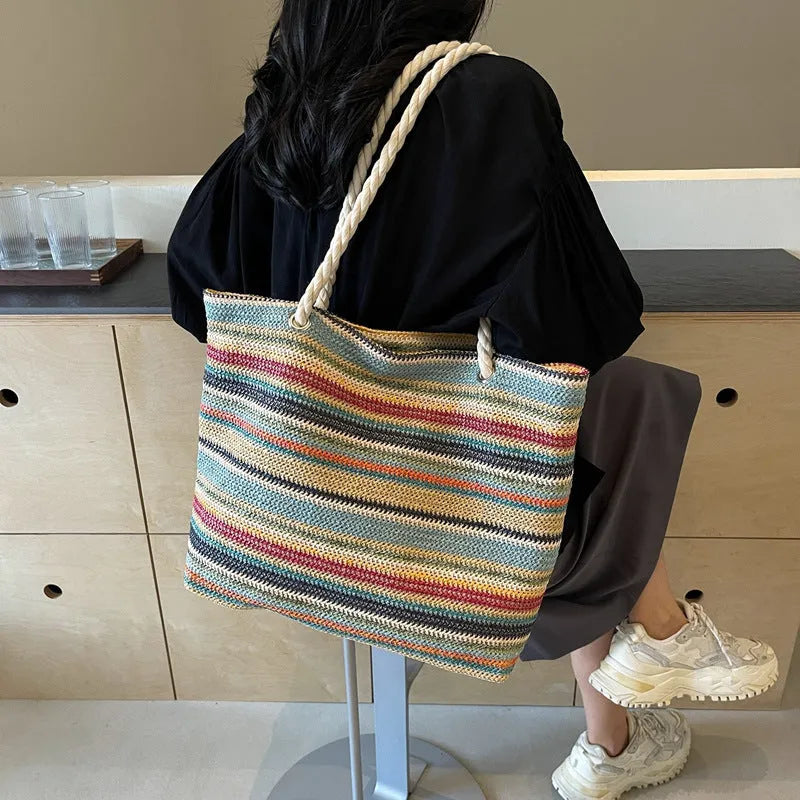 Blue straw and nylon woven large shoulder bag with polyester lining.