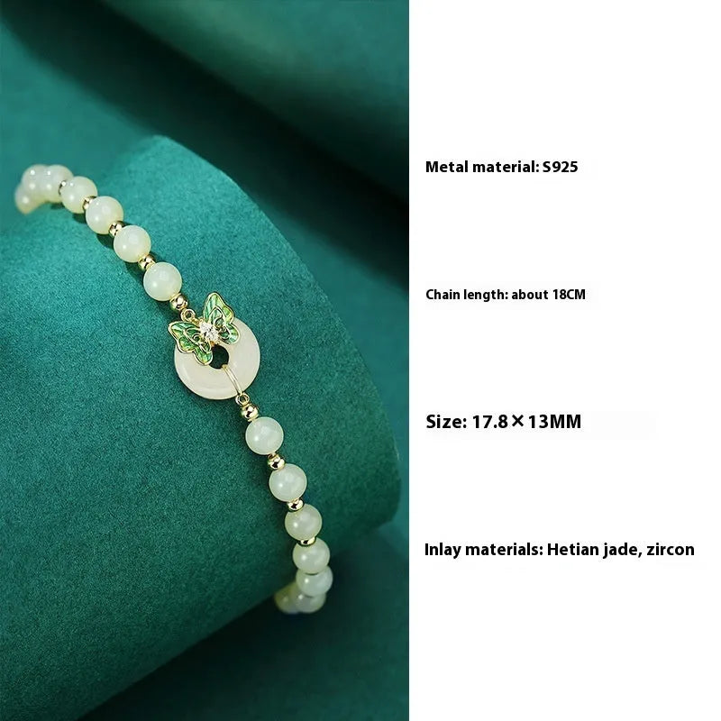 Cyan Hetian jade bracelet with a detailed sterling silver butterfly and gemstone ornament.