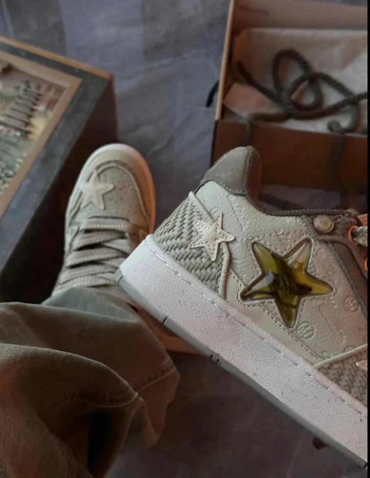 Green low-top casual sneakers with a star pattern design, round toe, and thick rubber sole.