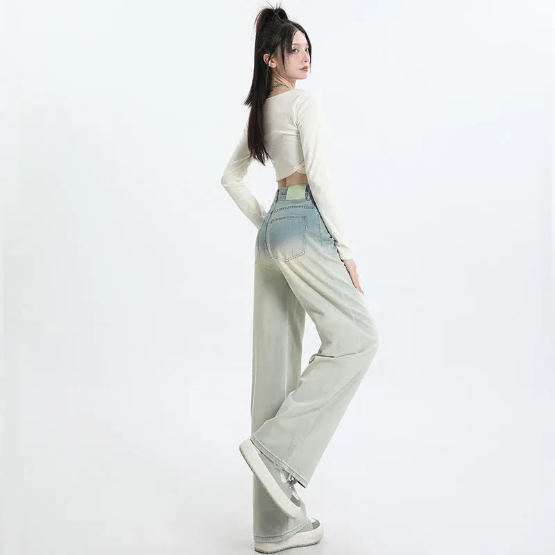 A pair of women's gradient blue wide-leg denim trousers on a neutral background.