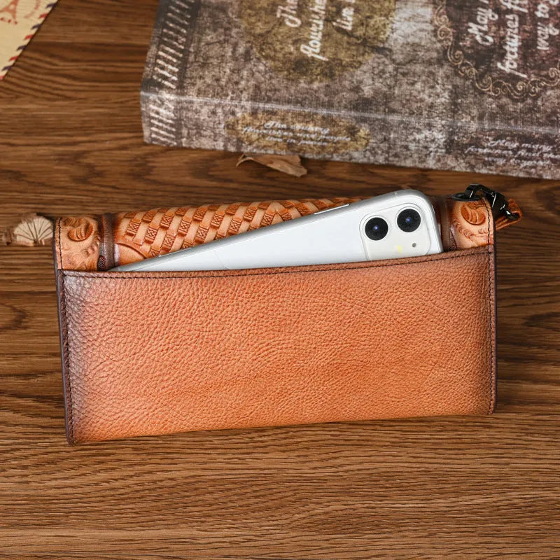 Retro brown embossed floral pattern tri-fold women's wallet made from genuine cowhide, shown open.