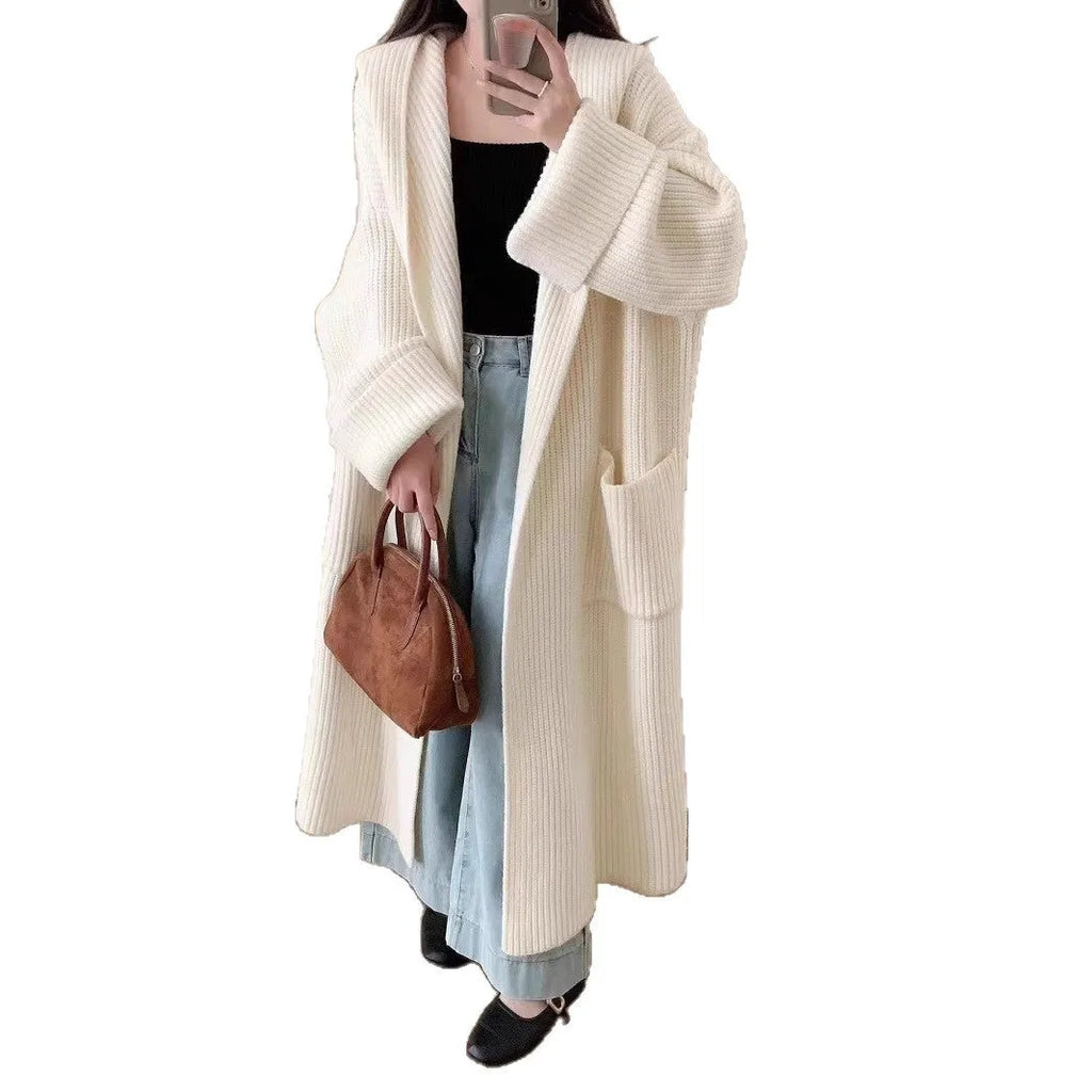 Loose grey hooded cardigan coat with long sleeves on a hanger