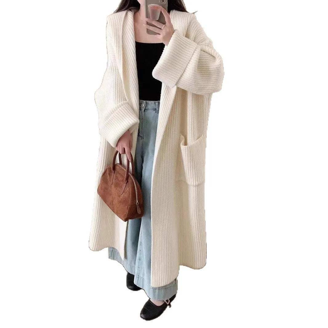 Loose grey hooded cardigan coat with long sleeves on a hanger