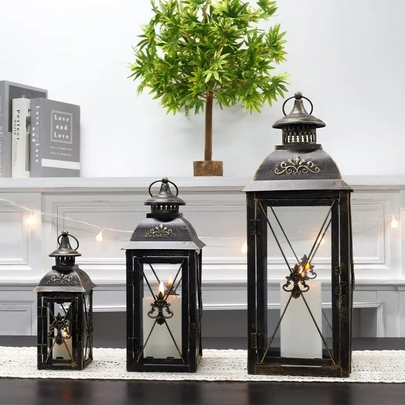 European-style black wrought iron floor-standing storm lantern with tempered glass panels.