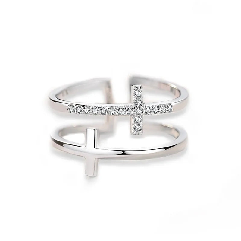 Adjustable double cross geometric ring with zircon stones in a white gold colour finish.