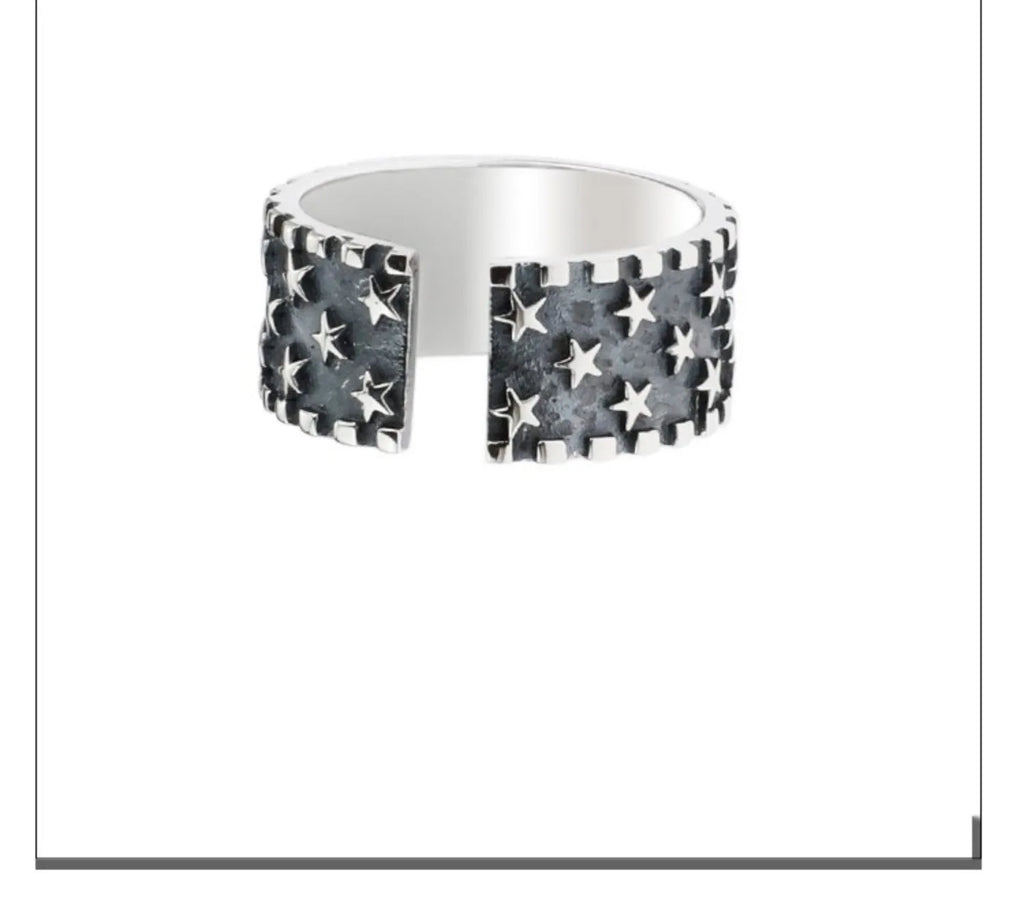 Adjustable silver ring with a geometric pattern of multiple five-pointed stars on the band.