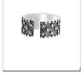 Adjustable silver ring with a geometric pattern of multiple five-pointed stars on the band.