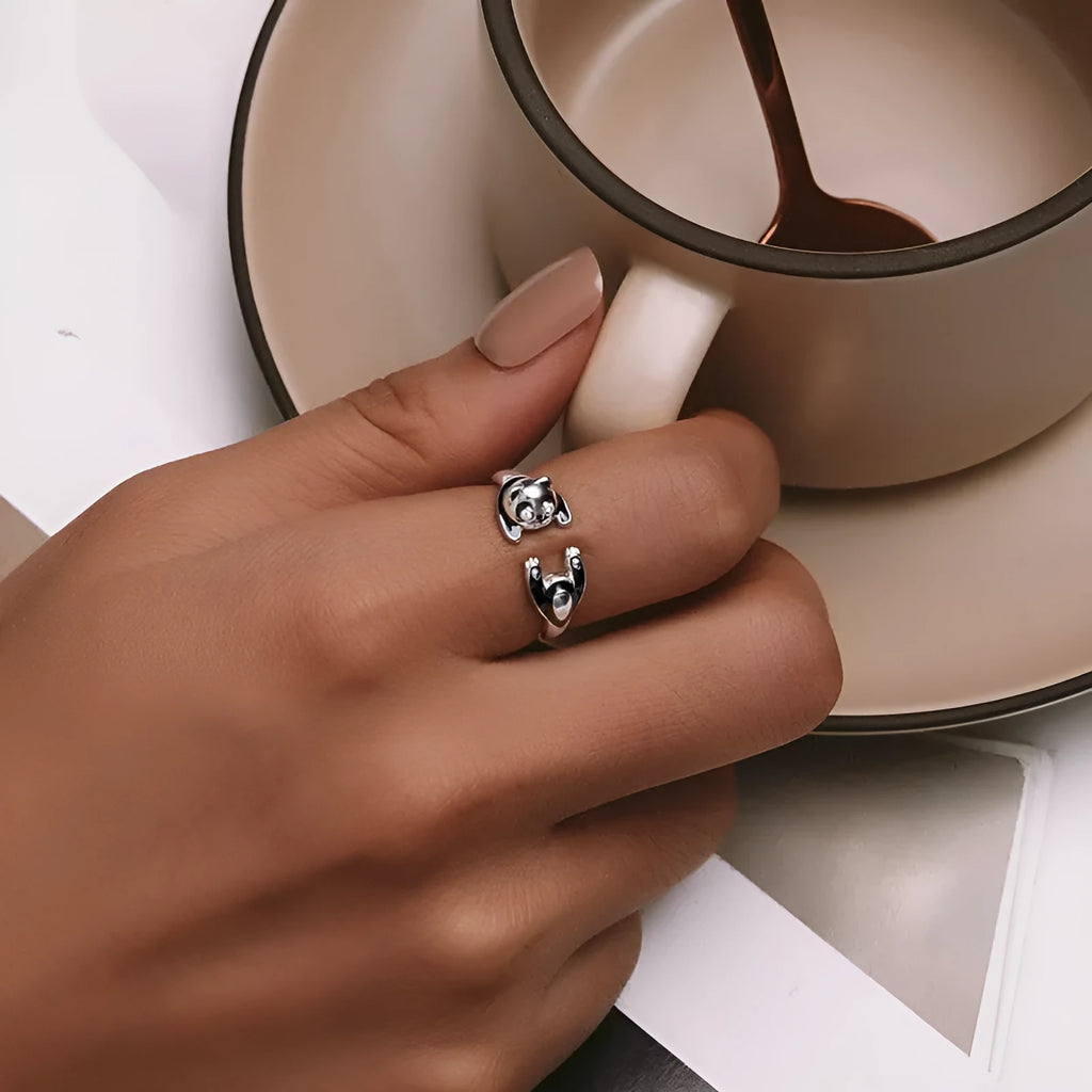 Adjustable sterling silver panda open ring with white gold plating on a finger
