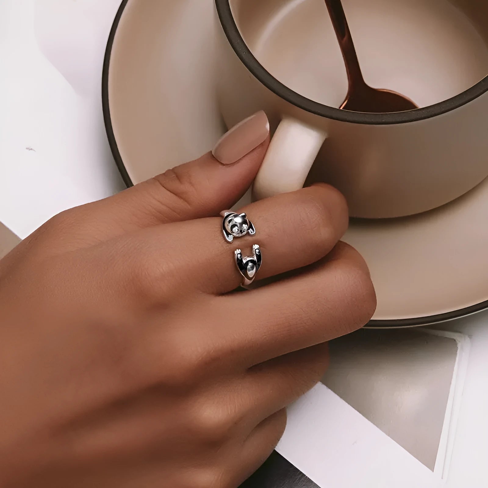 Adjustable sterling silver panda open ring with white gold plating on a finger