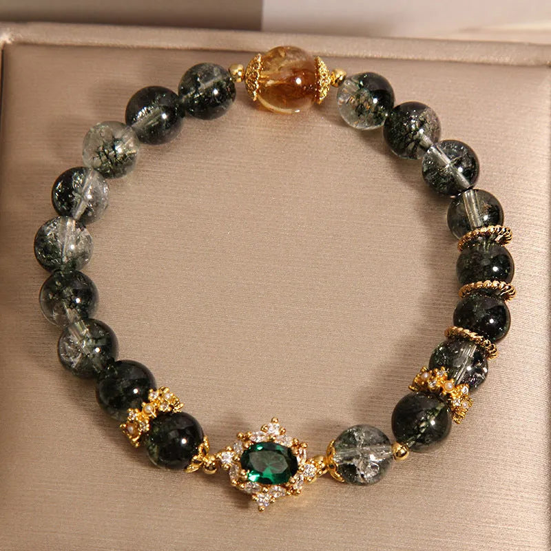 Gold rutilated quartz bracelet with green phantom quartz beads, gold ruby quartz accents, pearl and rhinestone details
