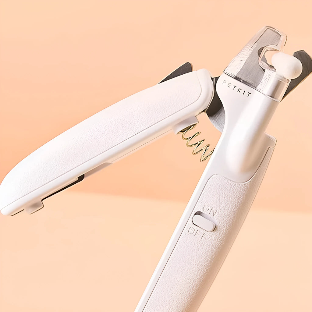 White pet nail clippers with LED light on the handle and a clear anti-splash guard covering the blades.