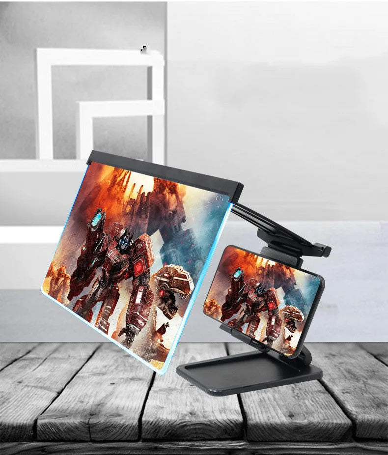 Black folding mobile phone screen magnifier with detachable holder on a desk.
