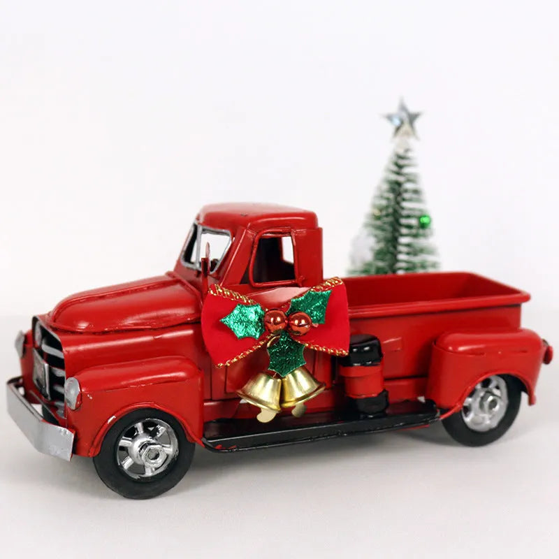 Retro red wrought iron Christmas truck ornament on a white surface, side view showing 17 cm length
