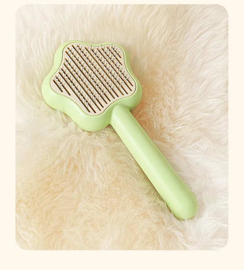 Green or yellow handheld self-cleaning magic wand pet comb with stainless steel needles.