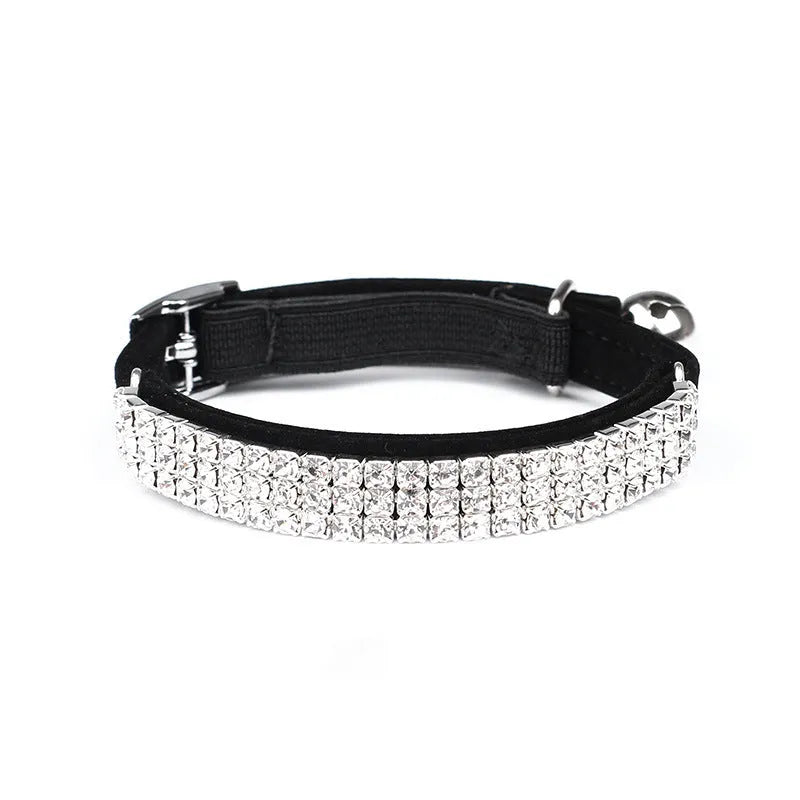A soft velvet cat collar with a central rhinestone, shown in one of five available colours.