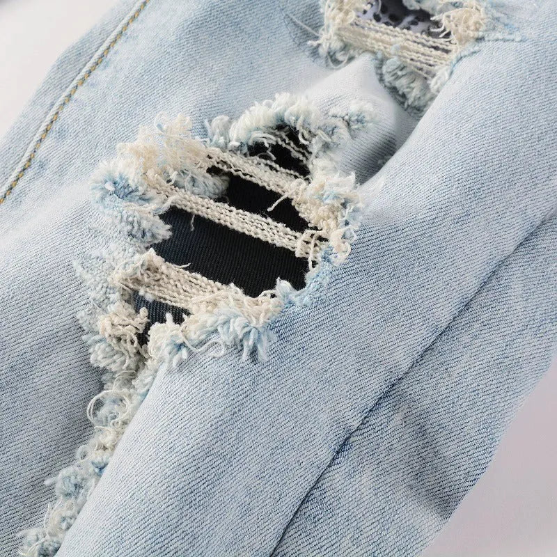 Light blue slim fit stretch men's jeans with distressed details and diamond patch pocket
