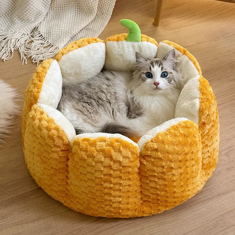 Pumpkin-shaped pet nest with raised sides and cotton filling for cats and small dogs
