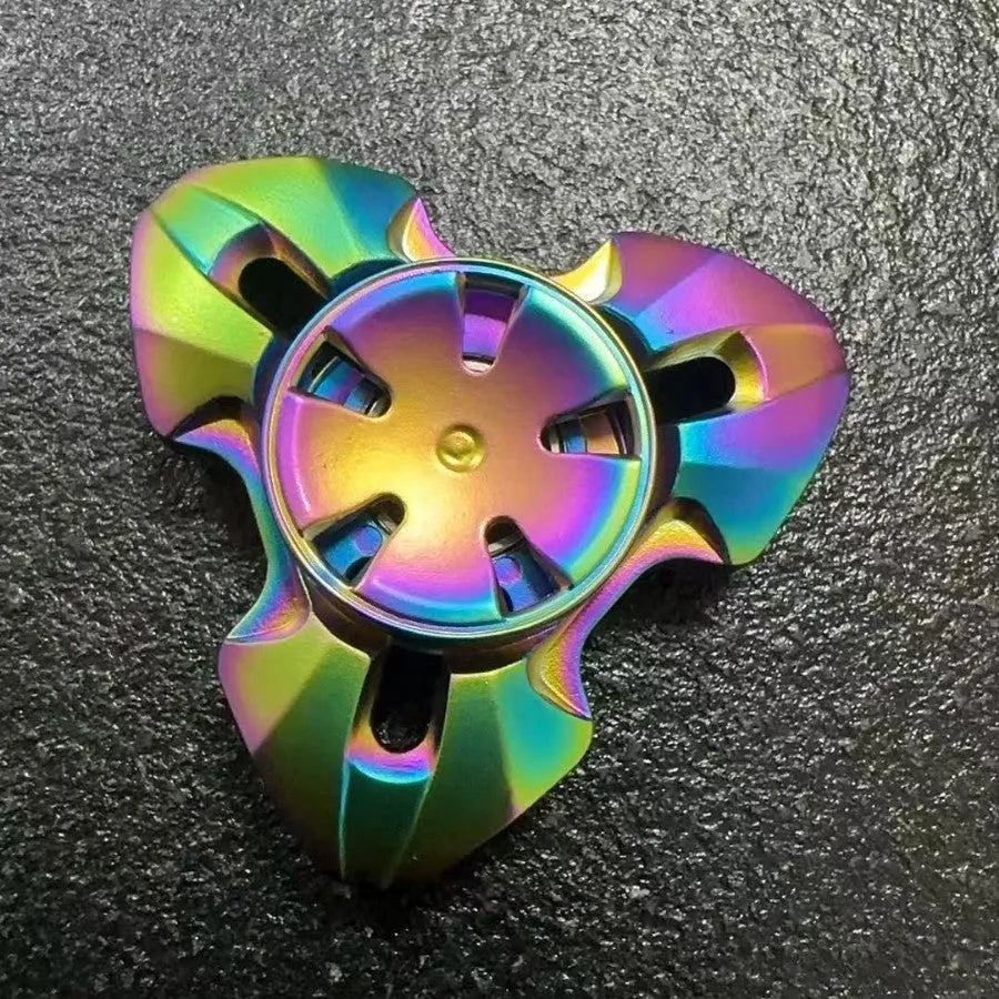 Metal alloy decompression toy with a rotating gyro, shown in gun colour and colourful options.