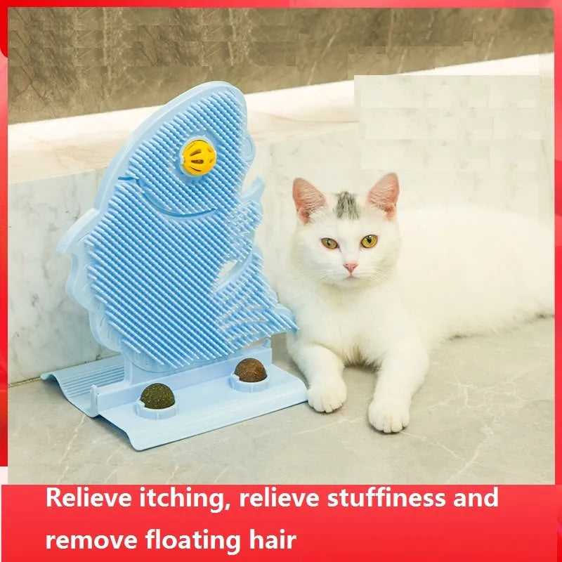 Blue plastic fish-shaped cat wall scratcher with brush, two green catnip balls, a bell, and a base.