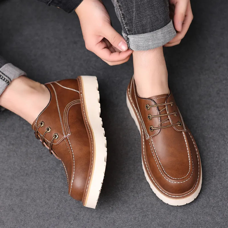 A pair of men's black retro-style low-top casual boots with a round toe and a rubber sole.