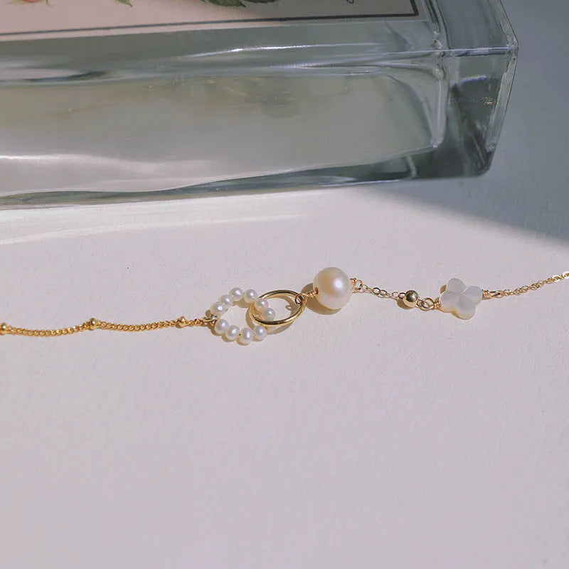Women's natural pearl bracelet with 14k gold-plated setting.