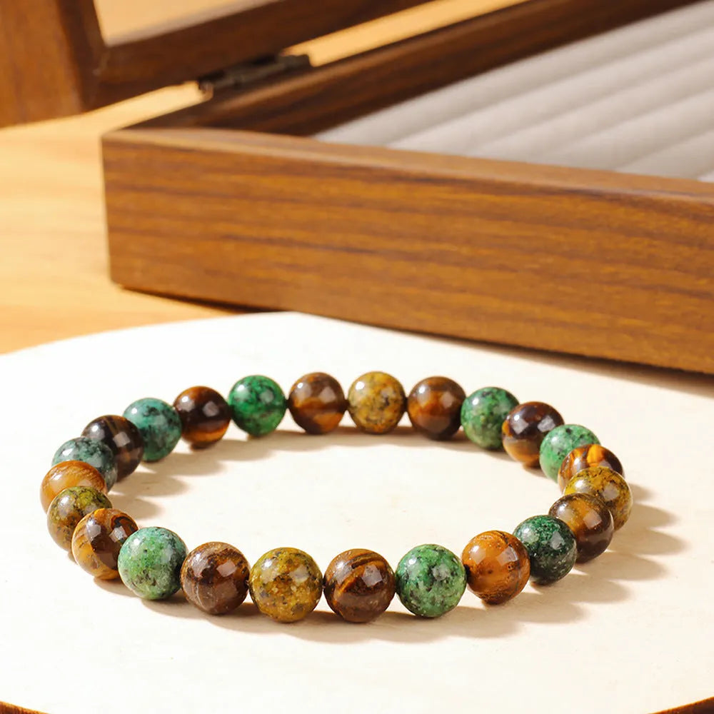 Handmade tigereye stone bracelet with 18mm flower-design beads on an adjustable strap.