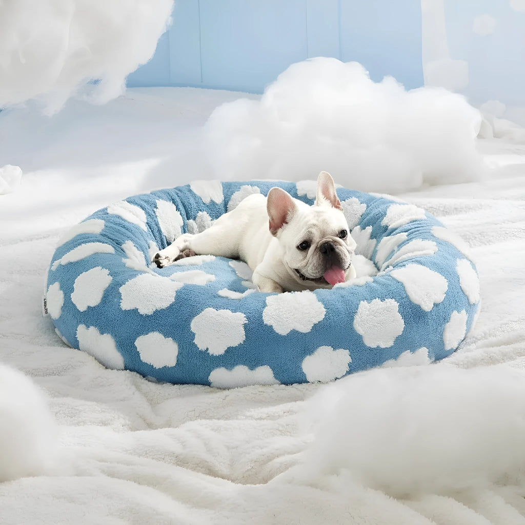 Round plaid dog bed with a plastic base shown in blue and white colours.