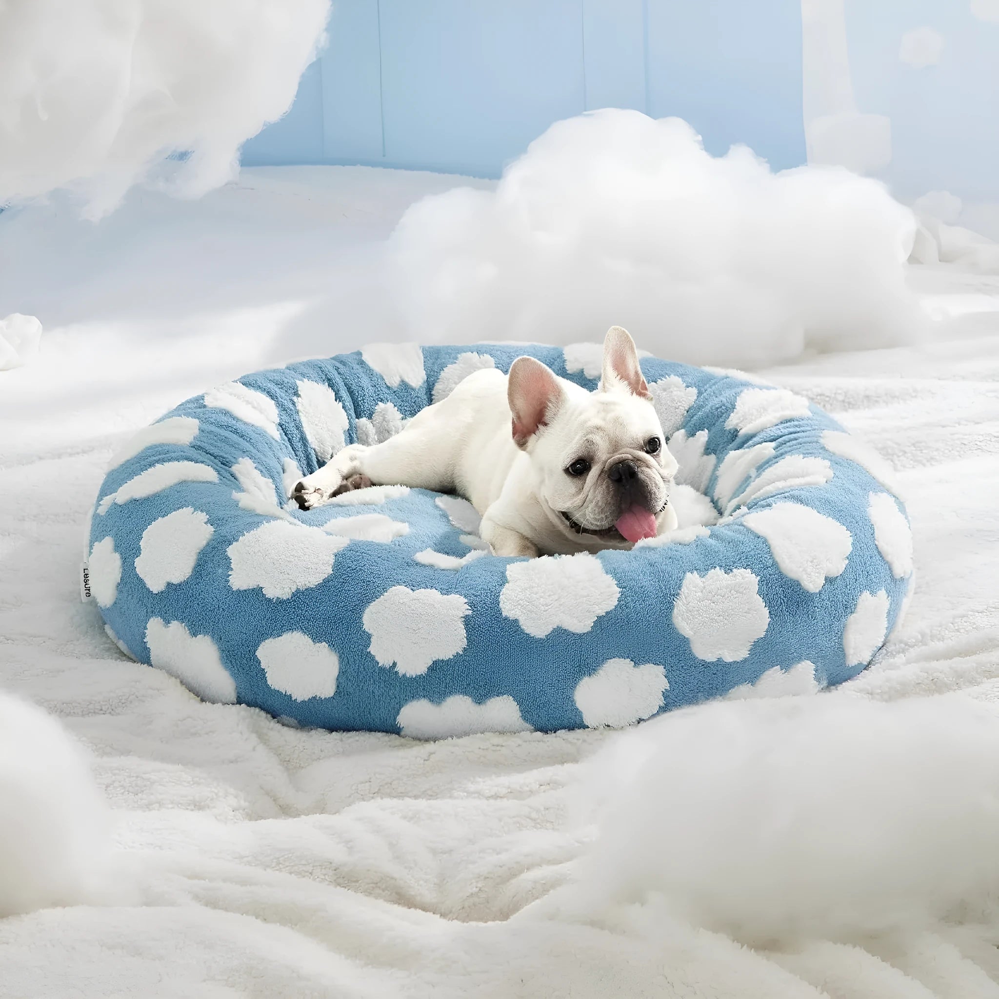 Round plaid dog bed with a plastic base shown in blue and white colours.