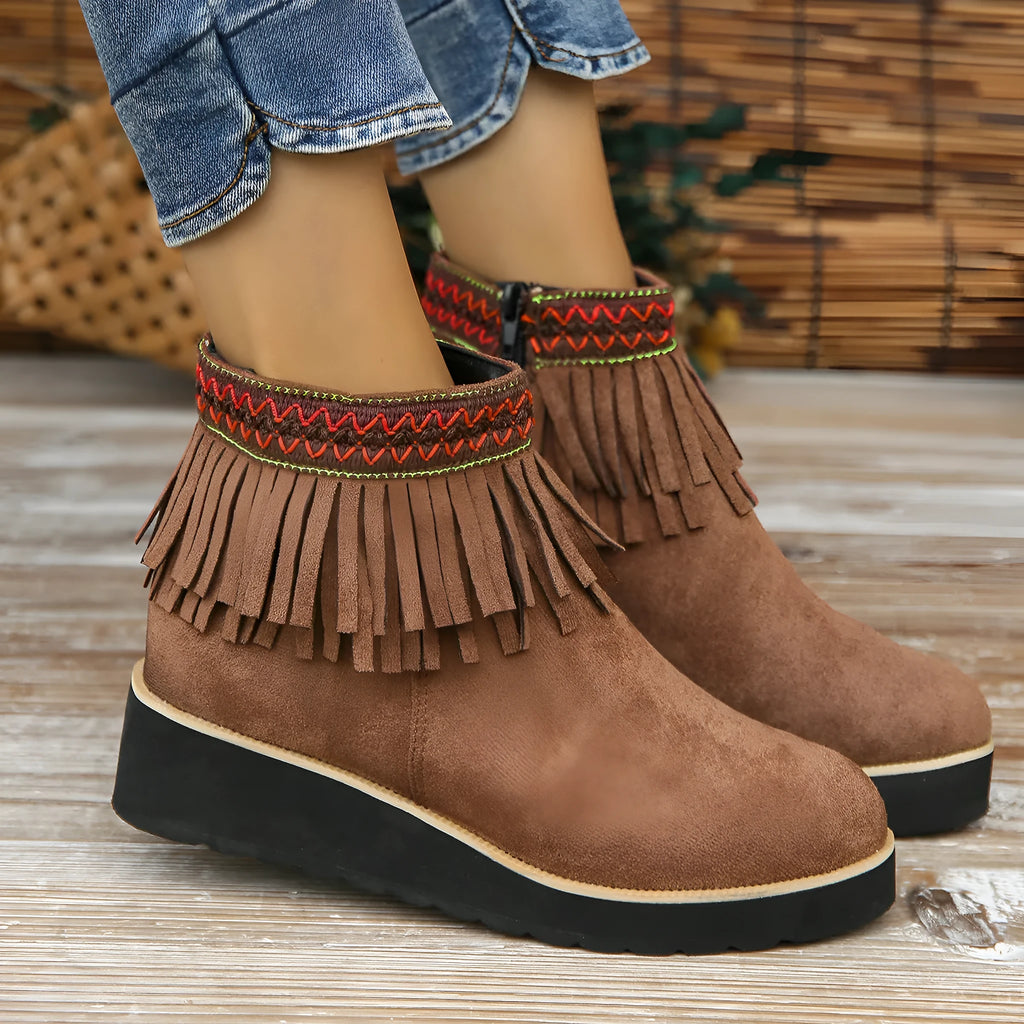 Women's dark brown suede wedge ankle boots with a side zipper and decorative tassels.