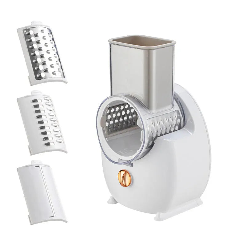 White electric kitchen vegetable slicer with multiple blades and a suction base on a countertop.