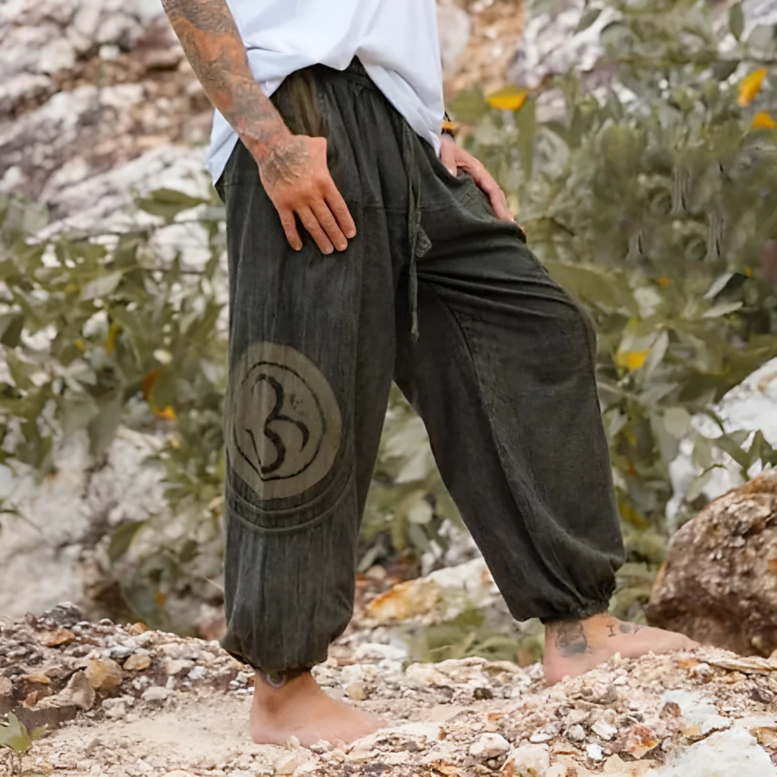 Dark green men's trousers with ethnic pattern and ankle-tied detail on polyester fabric